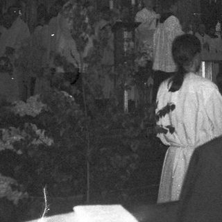 Gothic cathedral interior during nighttime service.