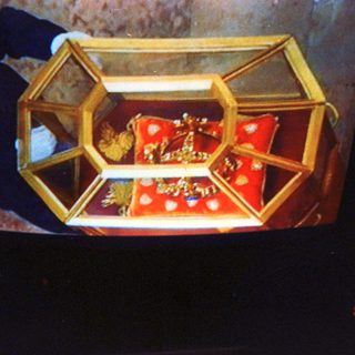 Religious relic housed in ornate golden case.