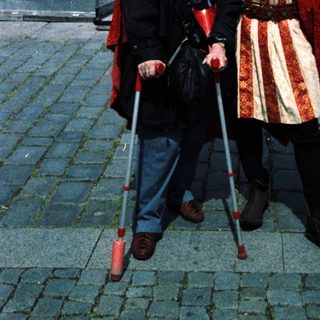 Two people dressed in medieval costumes posing outdoors.