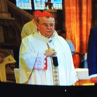 Religious ceremony with bishop and dignitary.