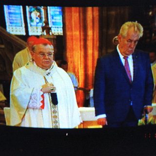 Religious ceremony with bishop and dignitary.