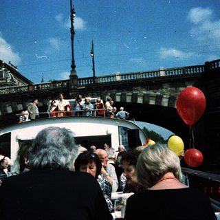 Boat party with people enjoying river cruise.