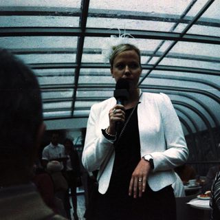 Person speaking into microphone on stage.