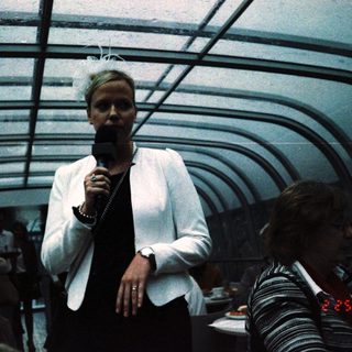 Person speaking into microphone on stage.