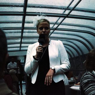 Person speaking into microphone on stage.