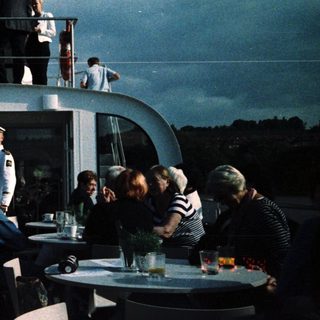 Luxury boat party with guests on deck.
