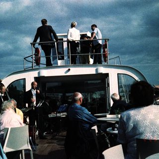 People dining on a floating restaurant boat.