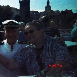 People posing with Prague skyline in background.