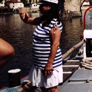 Boat operator near historic Charles Bridge in Prague.