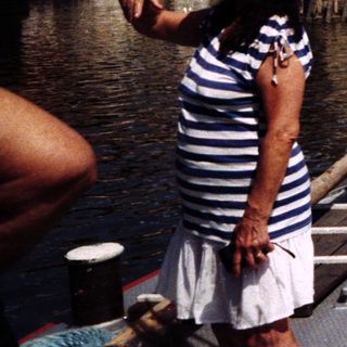 Boat operator near historic Charles Bridge in Prague.