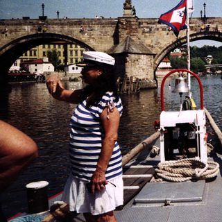 Boat operator near historic Charles Bridge in Prague.
