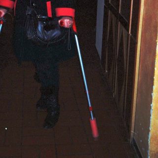Person dressed in red lightsaber costume.