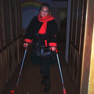 Person dressed in red lightsaber costume.