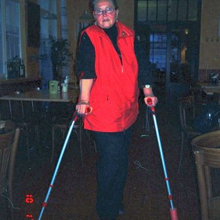 Person using illuminated walking poles indoors.