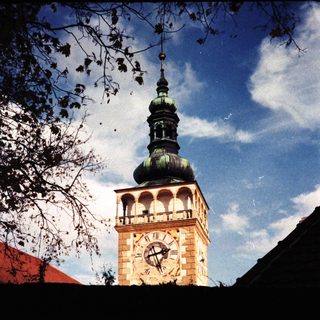 Historic clock tower with green spire.
