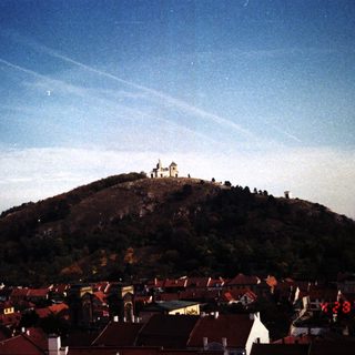 Historic castle atop hill overlooking town.