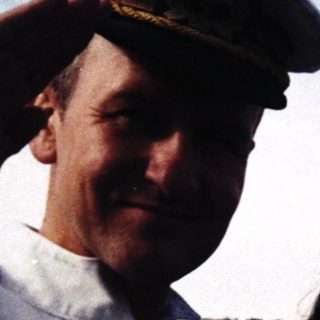 Three people posing outdoors in vintage naval caps, dated 1993.