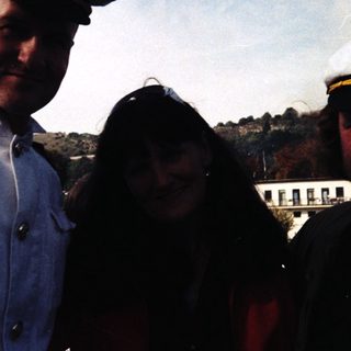 Three people posing outdoors in vintage naval caps, dated 1993.