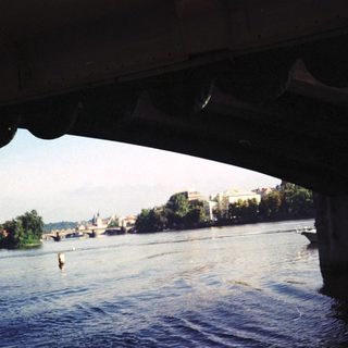 River scene with castle ruins and swimmer.