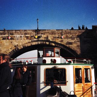 Historic bridge with boat tour beneath.