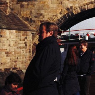 Historic bridge with boat tour beneath.