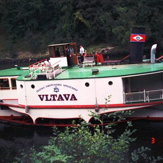 Riverboat named Vltava on water.