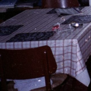 Two women in a kitchen during snowfall.