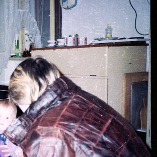 Family gathering indoors with adults and young children.