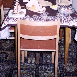 Young man sitting at a vintage dining table.