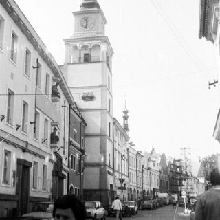 Historic European street with clock tower.