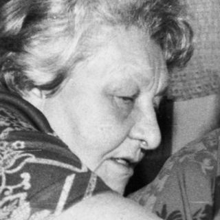 Two elderly women playing board game together.