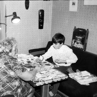 Two women and a child playing board game.