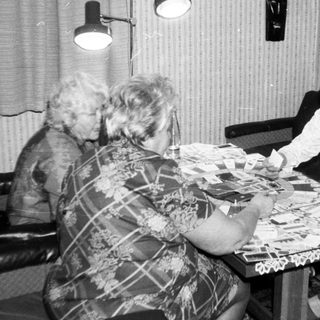 Two women and a child playing board game.