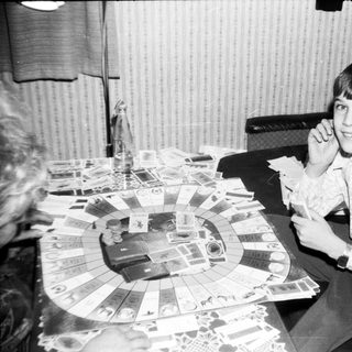 Young boy playing board game indoors.