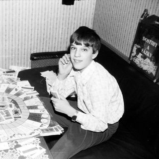 Young boy playing board game indoors.