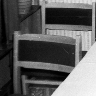 Young boy sitting at table with birthday cake.