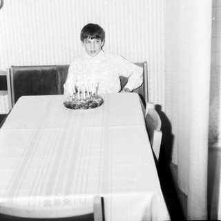 Child sitting at table with birthday candles.