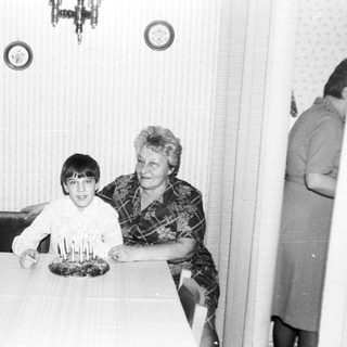 A woman and boy celebrating a birthday with candles.