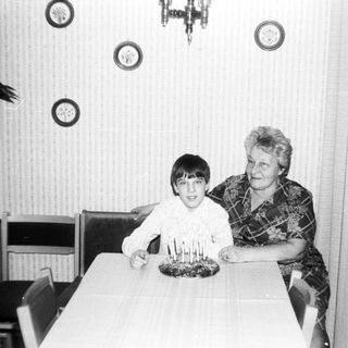 A woman and boy celebrating a birthday with candles.