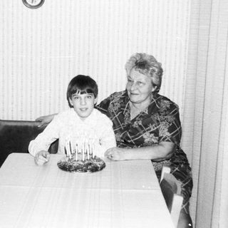 A woman and boy celebrating a birthday with candles.