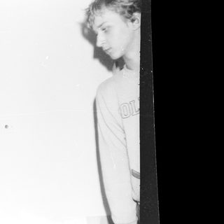 Blurred black-and-white photo of two people indoors.