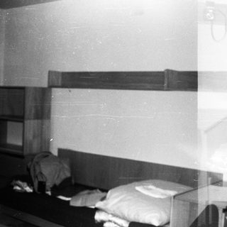 Small, dated bedroom with bunk beds and minimal furnishings.