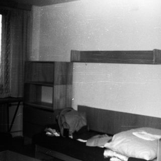 Small, dated bedroom with bunk beds and minimal furnishings.