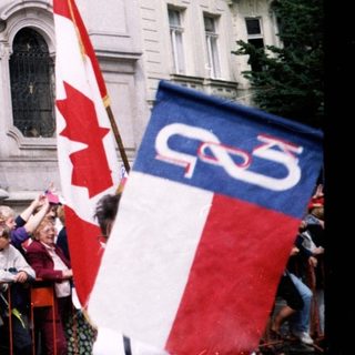 Polish-Canadian gathering with flags and signs.