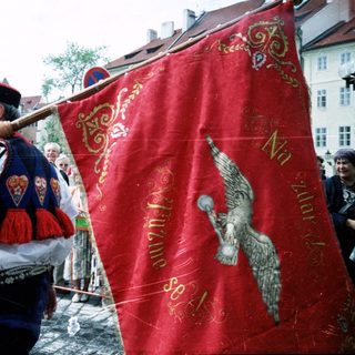 Traditional folk festival with ornate banner and costumes.