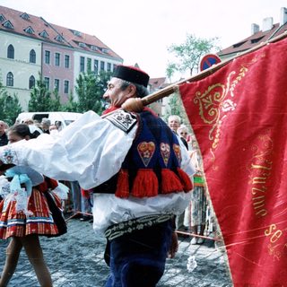 Traditional folk festival with ornate banner and costumes.