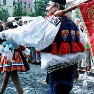 Traditional folk festival with ornate banner and costumes.
