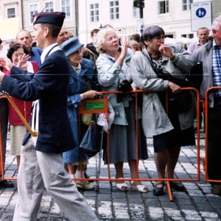 Military veterans parade with flags in public.