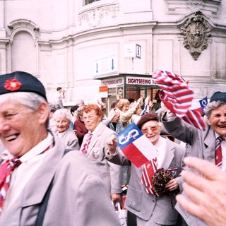 Veterans parade with flags and badges.