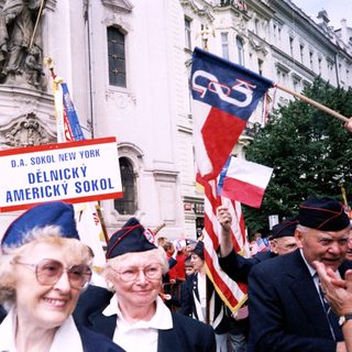 Polish-American cultural parade participants with flags.